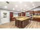 Large kitchen features an island, stainless steel appliances, granite counters, and dark wood cabinetry at 8275 W Craig Rd, Las Vegas, NV 89129
