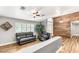 Living room showcasing decorative accent wall, wood-look floors, and stylish furnishings at 8275 W Craig Rd, Las Vegas, NV 89129