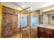 Main bathroom featuring a tiled glass-enclosed shower and dual vanities at 8275 W Craig Rd, Las Vegas, NV 89129