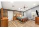 Spacious main bedroom with vaulted ceilings, wood floors, and a decorative accent wall at 8275 W Craig Rd, Las Vegas, NV 89129