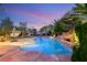 Tranquil pool area showcasing lush landscaping, stone accents, and a putting green at 8275 W Craig Rd, Las Vegas, NV 89129