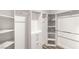 This walk-in closet features custom shelving, hanging racks, and built-in drawers for optimal organization at 8275 W Craig Rd, Las Vegas, NV 89129