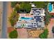 Birds eye view showing the pool and patio spaces with the modern house covered in solar panels and lush landscaping at 8525 W Verde Way, Las Vegas, NV 89149