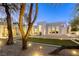 Picturesque outdoor living space with manicured lawn and patio is framed by mature trees at 8525 W Verde Way, Las Vegas, NV 89149