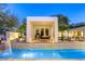 Backyard oasis featuring a pristine pool, dining area, and ample seating for relaxation and entertainment at 8525 W Verde Way, Las Vegas, NV 89149