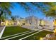 Backyard featuring a modern design, complete with artificial turf, outdoor fireplace, and a serene ambiance at 8525 W Verde Way, Las Vegas, NV 89149