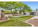 Beautiful zen backyard featuring mature trees and lush green lawn at 8525 W Verde Way, Las Vegas, NV 89149