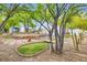 Backyard with a lush putting green surrounded by desert landscaping at 8525 W Verde Way, Las Vegas, NV 89149