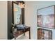 Stylish powder room with vessel sink, pendant lighting, dark walls, wood accent furniture, and a unique mirror at 8525 W Verde Way, Las Vegas, NV 89149