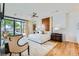 Spacious bedroom featuring hardwood floors, designer headboard, ceiling fan and large windows with view to backyard at 8525 W Verde Way, Las Vegas, NV 89149