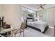 Bright bedroom with a ceiling fan, large windows, and comfortable bed setup at 8525 W Verde Way, Las Vegas, NV 89149