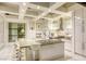 Open kitchen with expansive center island, modern appliances, and coffered ceilings at 8525 W Verde Way, Las Vegas, NV 89149