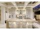 Open kitchen with expansive center island, modern appliances, and coffered ceilings at 8525 W Verde Way, Las Vegas, NV 89149