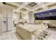 Open kitchen with expansive center island, modern appliances, and coffered ceilings at 8525 W Verde Way, Las Vegas, NV 89149