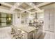 Open kitchen with expansive center island, modern appliances, and coffered ceilings at 8525 W Verde Way, Las Vegas, NV 89149