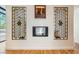 Living room boasting hardwood floors, contemporary fireplace with mantel and decorative sconces at 8525 W Verde Way, Las Vegas, NV 89149