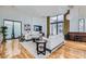 Inviting living room with stylish decor, hardwood flooring, and large windows for plenty of light at 8525 W Verde Way, Las Vegas, NV 89149
