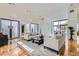 Bright and open living room with hardwood floors and modern light fixtures at 8525 W Verde Way, Las Vegas, NV 89149