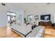 Spacious living room featuring hardwood floors, modern furniture, and ample natural light at 8525 W Verde Way, Las Vegas, NV 89149
