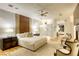 Bright main bedroom featuring a ceiling fan, wooden floors, a decorative headboard, and a full ensuite bathroom at 8525 W Verde Way, Las Vegas, NV 89149
