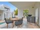A contemporary outdoor seating area with a modern wood table and bar at 8525 W Verde Way, Las Vegas, NV 89149
