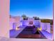 Relaxing rooftop patio featuring an outdoor fireplace, lounge chairs, and views at 8525 W Verde Way, Las Vegas, NV 89149