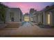 Twilight view of a modern home's water feature and landscape at 8525 W Verde Way, Las Vegas, NV 89149
