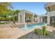 A sleek water feature enhances the modern outdoor space with a pool at 8525 W Verde Way, Las Vegas, NV 89149