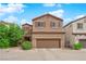 Charming two-story home with a two-car garage and desert landscaping under a bright blue, partly cloudy sky at 9024 Hazy Haven Ct, Las Vegas, NV 89149