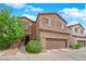 Charming two-story home with a two-car garage and desert landscaping under a bright blue, partly cloudy sky at 9024 Hazy Haven Ct, Las Vegas, NV 89149