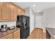 Well-maintained kitchen with stainless steel refrigerator and wooden cabinets at 9024 Hazy Haven Ct, Las Vegas, NV 89149