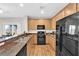 Well-lit kitchen featuring stainless steel appliances, light cabinets, and granite countertops at 9024 Hazy Haven Ct, Las Vegas, NV 89149
