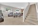 Open living room with staircase, neutral paint, and view into the kitchen and dining areas at 9024 Hazy Haven Ct, Las Vegas, NV 89149