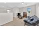 Upstairs living room features a futon, TV, bookshelf, and neutral carpet at 9024 Hazy Haven Ct, Las Vegas, NV 89149