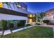Backyard space with artificial lawn, stone walkways, and mature landscaping at 917 Vegas View Dr, Henderson, NV 89052
