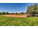 A baseball field sits within a vast green space, complete with backstop and tree-lined perimeter at 917 Vegas View Dr, Henderson, NV 89052