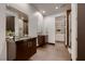 Modern bathroom with dual vanities, sleek fixtures, and a spacious glass-enclosed shower, next to walk-in closet at 917 Vegas View Dr, Henderson, NV 89052