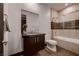 Bathroom featuring a single sink vanity, glass shower and tub at 917 Vegas View Dr, Henderson, NV 89052