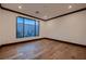 Bedroom featuring hardwood floors, a large window, and plenty of natural light at 917 Vegas View Dr, Henderson, NV 89052