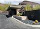Elegant community entrance with modern signage, desert landscaping, and a secure gatehouse at 917 Vegas View Dr, Henderson, NV 89052