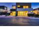 Modern home featuring a two-car garage with illuminated glass doors and contemporary design at 917 Vegas View Dr, Henderson, NV 89052