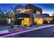 Contemporary home showcasing modern architecture and a well-manicured front yard at dusk at 917 Vegas View Dr, Henderson, NV 89052