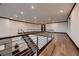 Open hallway with hardwood floors, modern railing, and recessed lighting providing a spacious and bright area at 917 Vegas View Dr, Henderson, NV 89052
