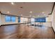 Spacious hallway with hardwood floors, modern railing, and large windows offering natural light and views at 917 Vegas View Dr, Henderson, NV 89052