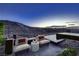 Tranquil patio with modern seating overlooking mountain views and a relaxing pool at 917 Vegas View Dr, Henderson, NV 89052