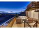Outdoor patio with a fireplace, modern seating, and city views at twilight at 917 Vegas View Dr, Henderson, NV 89052