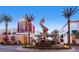 Outdoor shopping center featuring a modern sculpture, palm trees, and inviting storefronts at 917 Vegas View Dr, Henderson, NV 89052