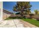 Backyard features concrete patio, manicured lawn and shade trees at 9491 Gainey Ranch Ave, Las Vegas, NV 89147