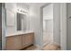 Bathroom boasts wood cabinets, white countertops and an open view of the adjacent light-filled room at 9491 Gainey Ranch Ave, Las Vegas, NV 89147