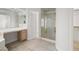 Bright bathroom featuring tiled floors, shower with gold trim, and vanity at 9491 Gainey Ranch Ave, Las Vegas, NV 89147